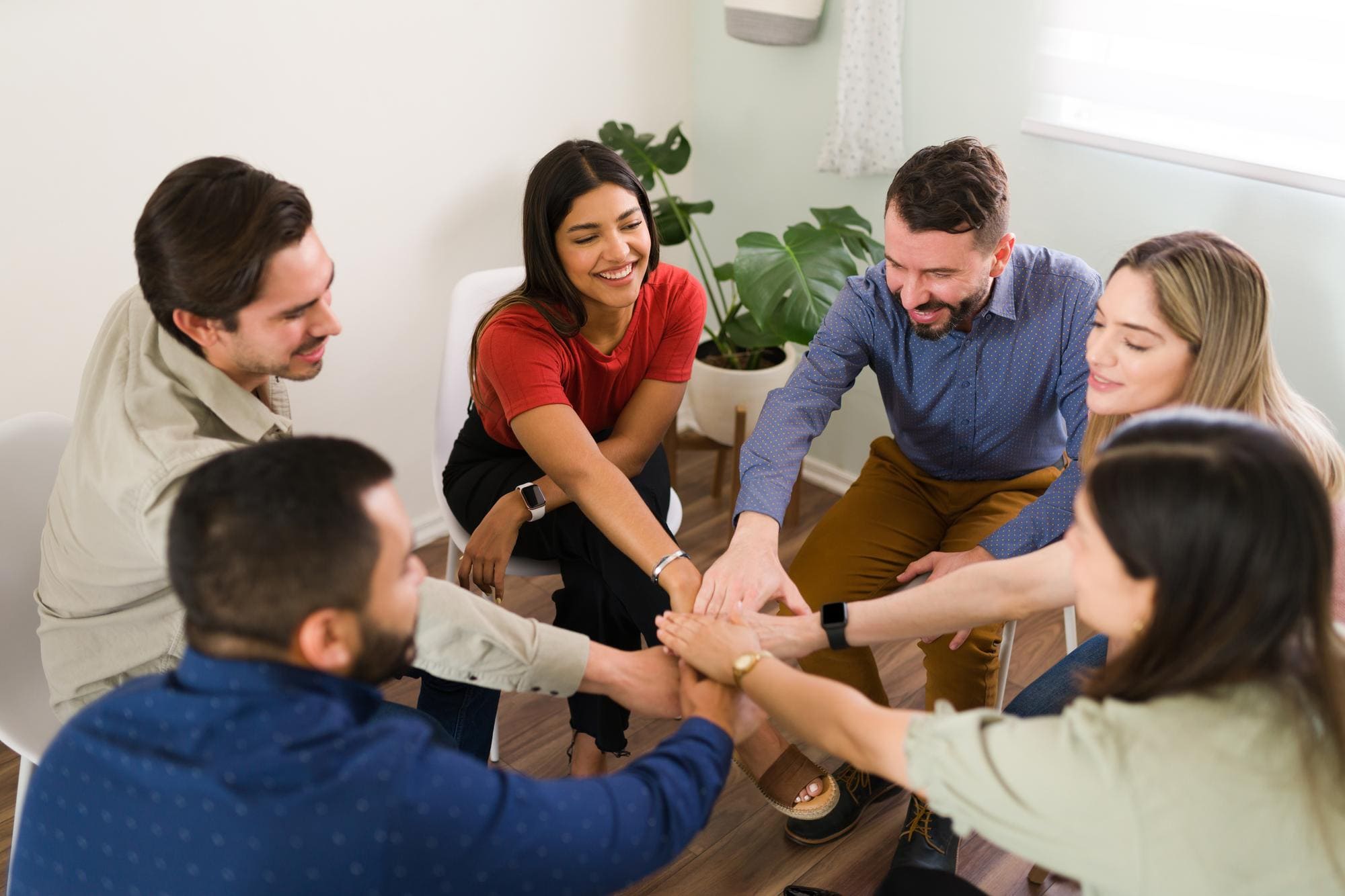Group of colleagues stacking hands for motivation and success